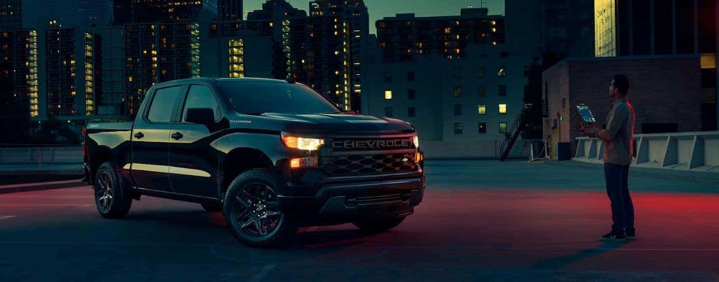 Black 2023 Chevy Silverado 1500 parked on the top of a parking garage