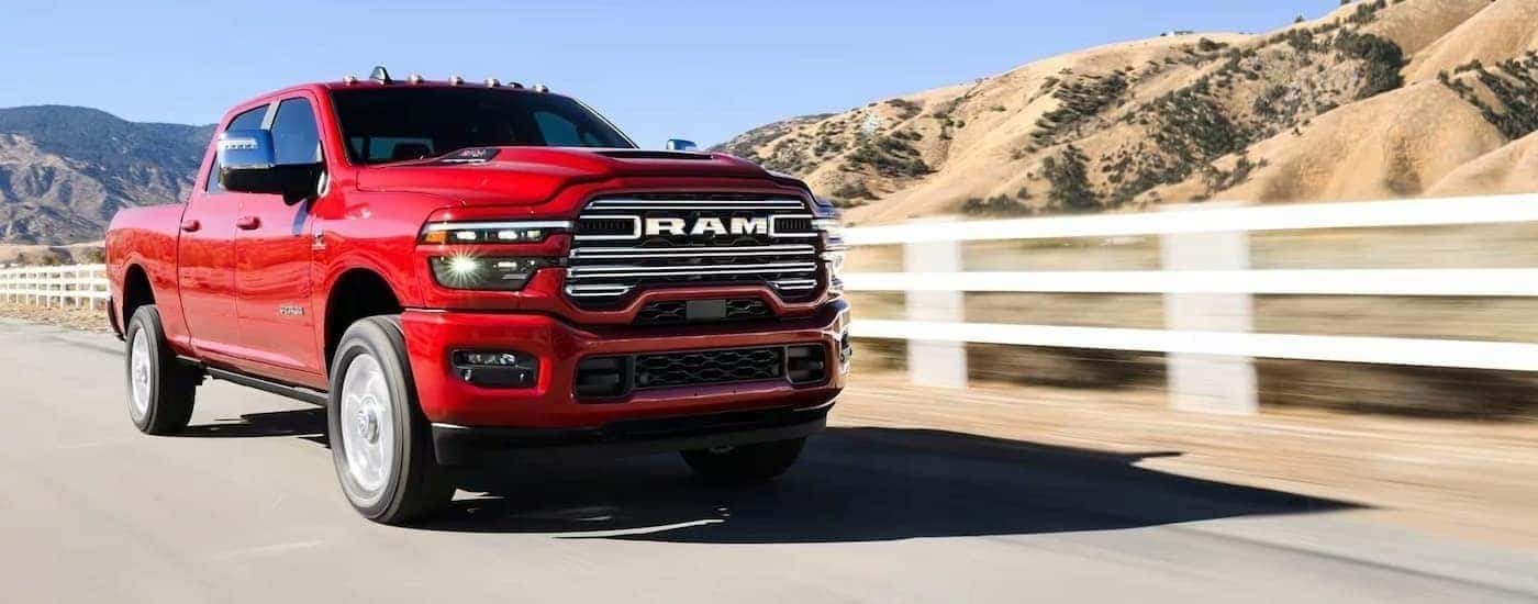 Red 2025 Ram 2500 LARAMIE driving to look at trucks for sale near Poughkeepsie
