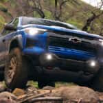 Blue 2026 Chevy Colorado off-roading on a rocky trail