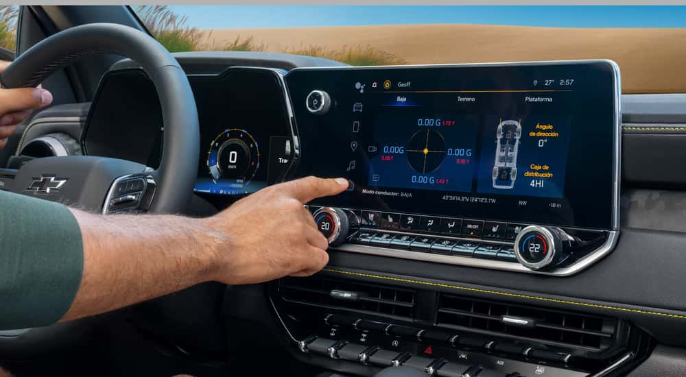 Man using the infotainment screen in a 2026 Chevy Colorado