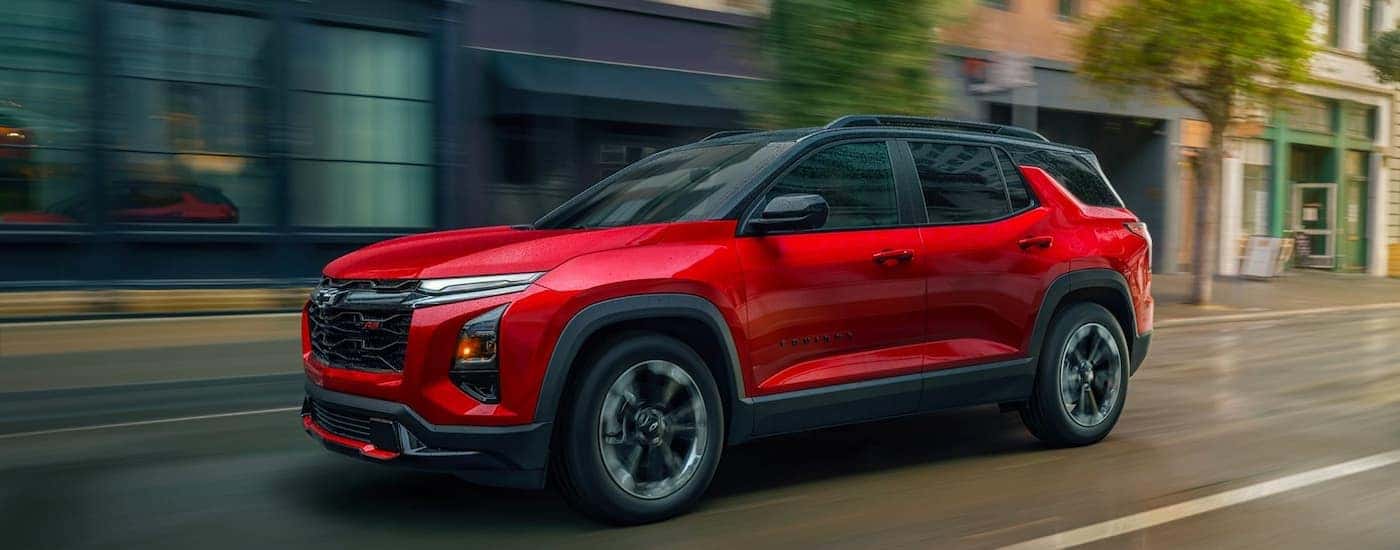 Red 2026 Chevy Equinox RS driving down a road.