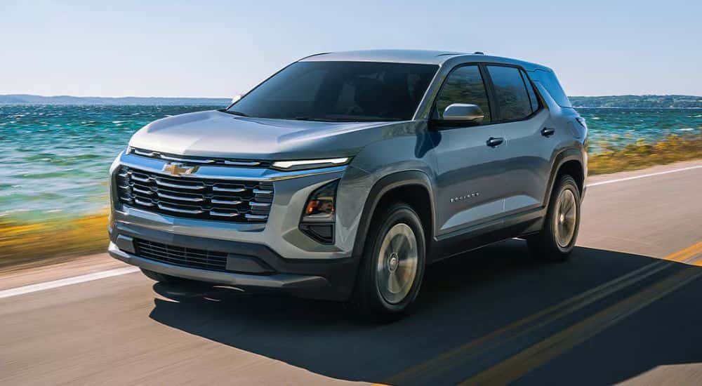 Grey 2026 Chevy Equinox driving along the water
