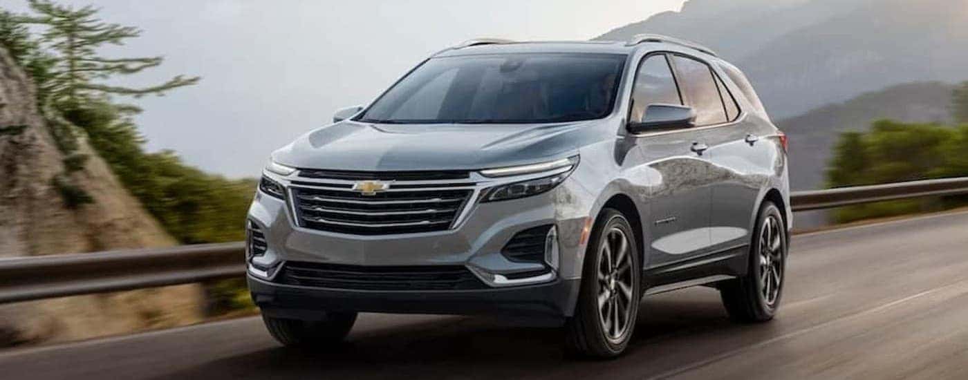A silver 2024 Chevy Equinox driving on a highway.