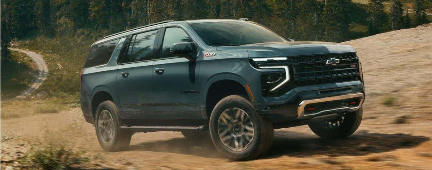A green 2026 Chevy Suburban Z71 off-roading.