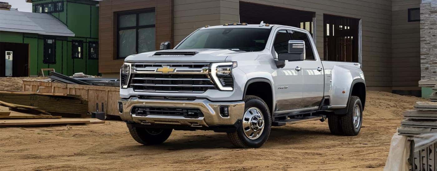 White 2026 Chevy Silverado 2500 parked off-road at a construction site.