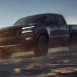 2022 Nissan Frontier driving in sand.