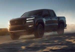 2022 Nissan Frontier driving in sand.