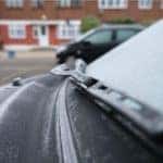 Image of vehicle wiper blades glossed over by rain