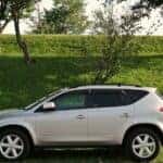 Nissan Murano parked by a hill at a park.