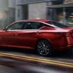 2023 Nissan Altima in Red driving on a city street
