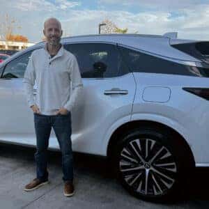 man standing on side of car