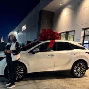 Woman Standing in front of New Car with Bow