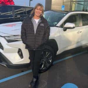 Woman Standign in Front of New Car