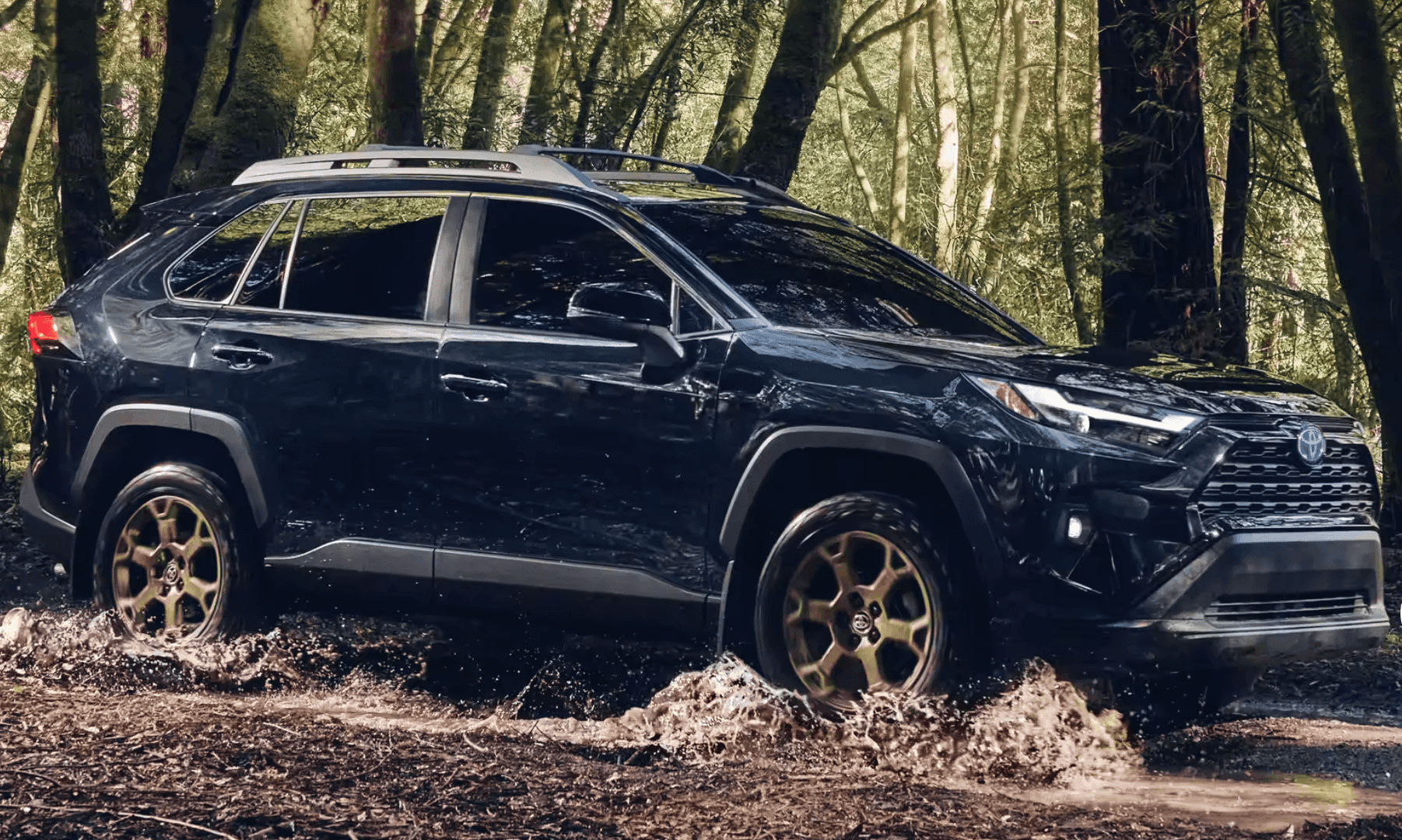 2023 RAV4 Hybrid Woodland Edition Driving through a puddle in the woods near Landers Toyota in Little Rock, AR