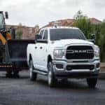 white dodge ram 2500 tradesman towing construction equipment