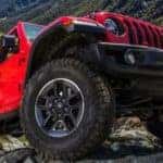 2022 red jeep wangler climbing up a hill showcasing the vehicles tires