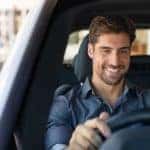 a gentlemen inside a vehicle he is about to test drive performing his own personal vehicle internal inspection before leaving