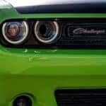 The grill of a bright green New Dodge Challenger.