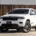 A white Jeep sits parked on a parking lot. Image demonstrates the cars available at your nearest Jeep dealer.