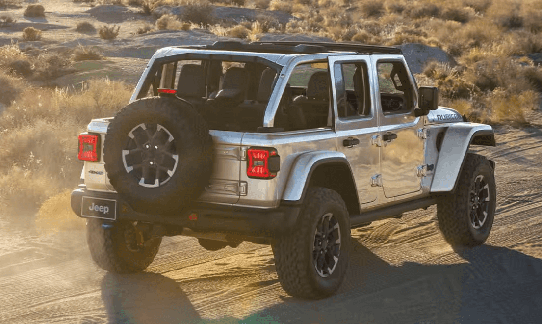 The back of a silver Jeep Rubicon 4xe driving in a desert setting (1)