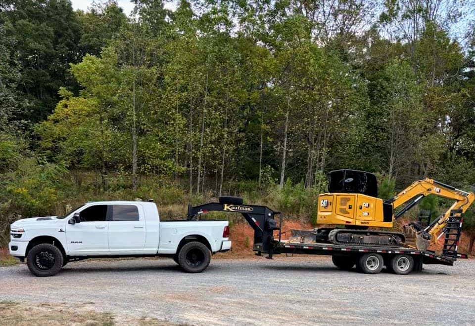 Custom Ram heavy duty truck towing construction equipment in North Georgia