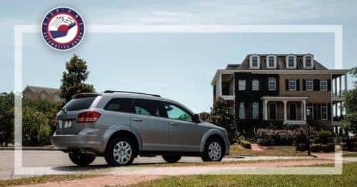 silver suv next to house