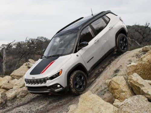 2024 Jeep Compass driving down a steep rocky hill