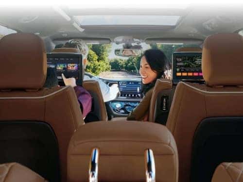 2024 Chrysler Pacifica view of mom in front seat looking back at child in back seat using entertainment system