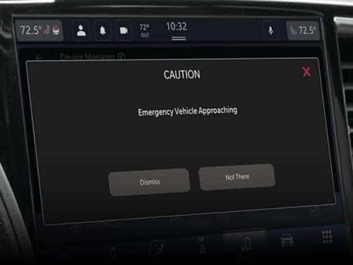2024 Chrysler Pacifica close up view of touchscreen displaying emergency vehicle alert 