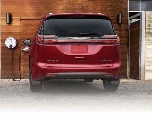 2024 Chrysler Pacifica PHEV rear exterior view of vehicle charging at home