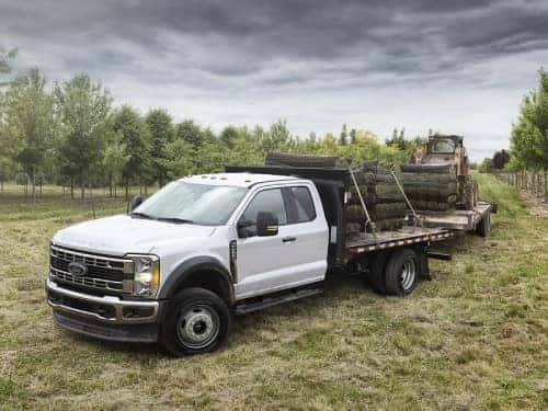 2024 RAM Chassis Cab towing a flatbed of lumber