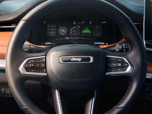 2025 Jeep Compass close up view of steering wheel and digital cluster display