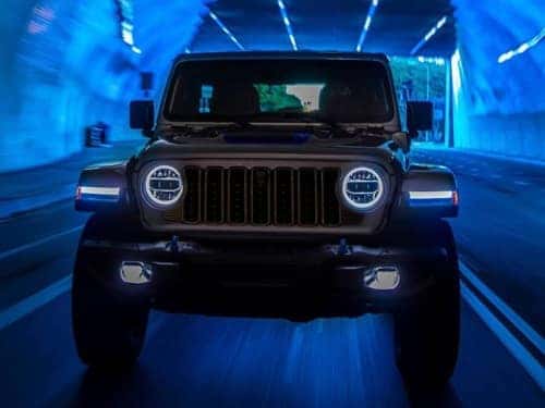 2024 Jeep Wrangler 4xe front view of vehicle driving through a tunnel