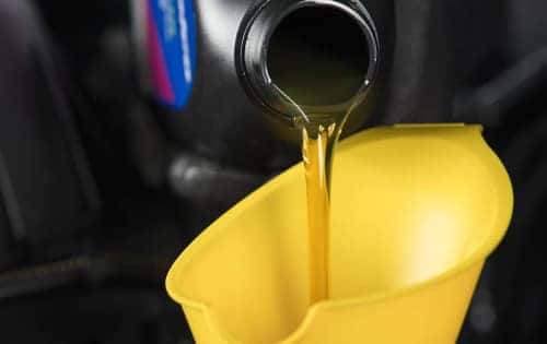 oil being poured into a funnel